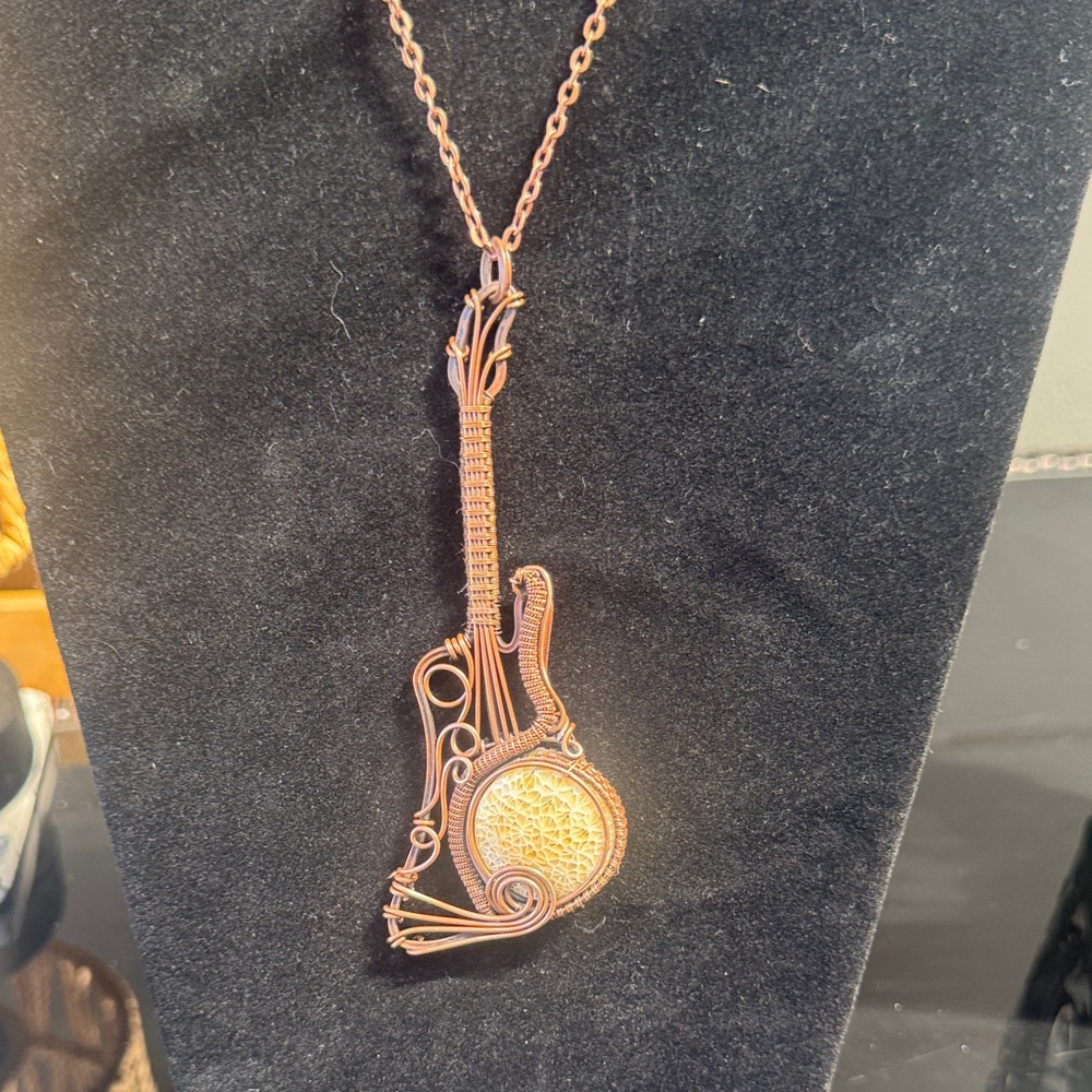 Hand Crafted Copper-Tone Wire Guitar Pendant with Fossilized Coral Stone